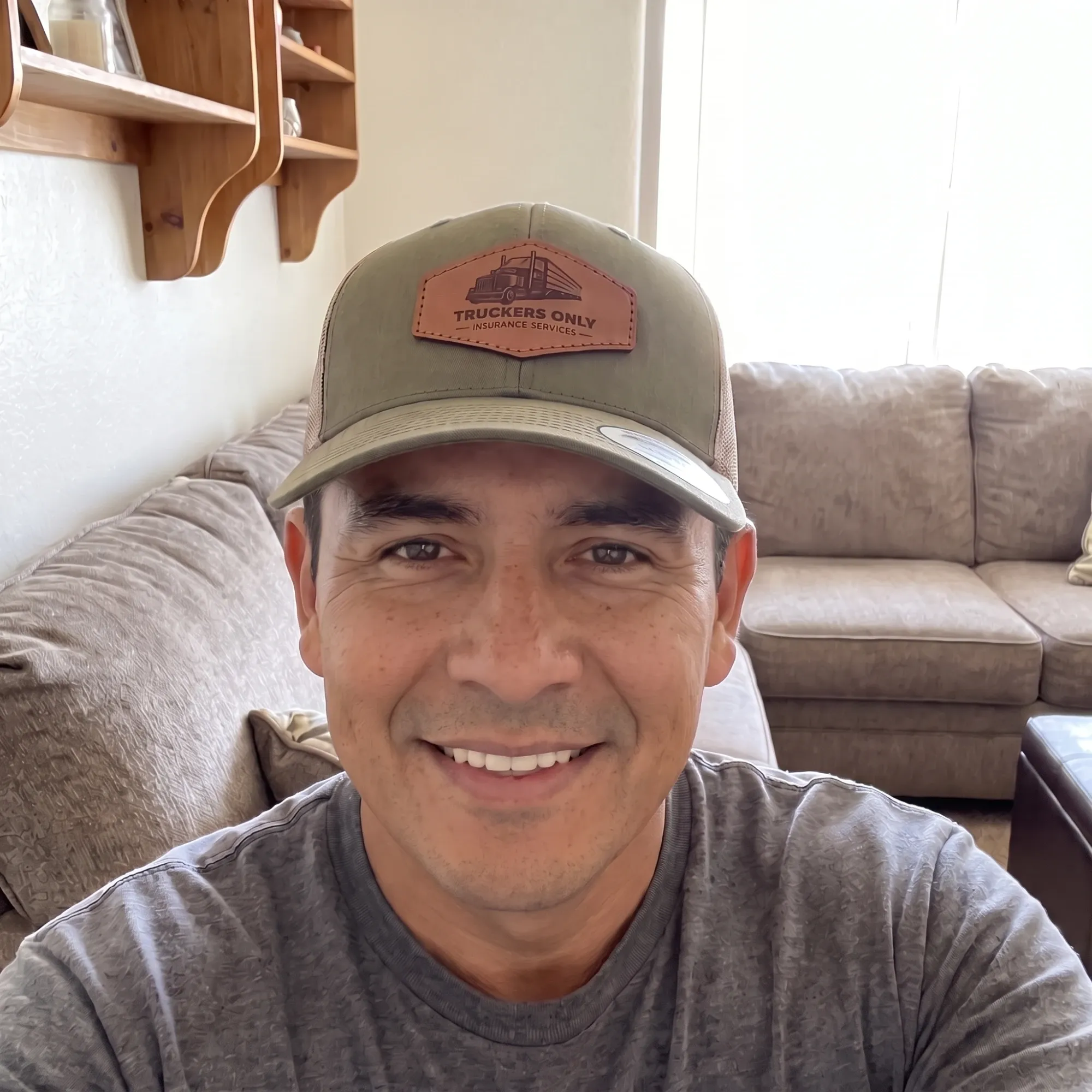 A customer at home wearing the 2026 Truckers Only cap